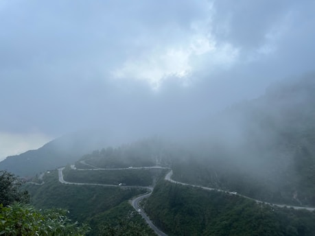 a winding road in the middle of a mountain