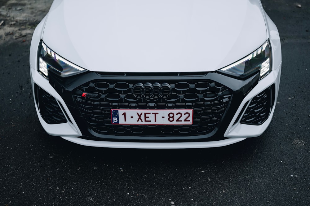 a close up of the front of a white car