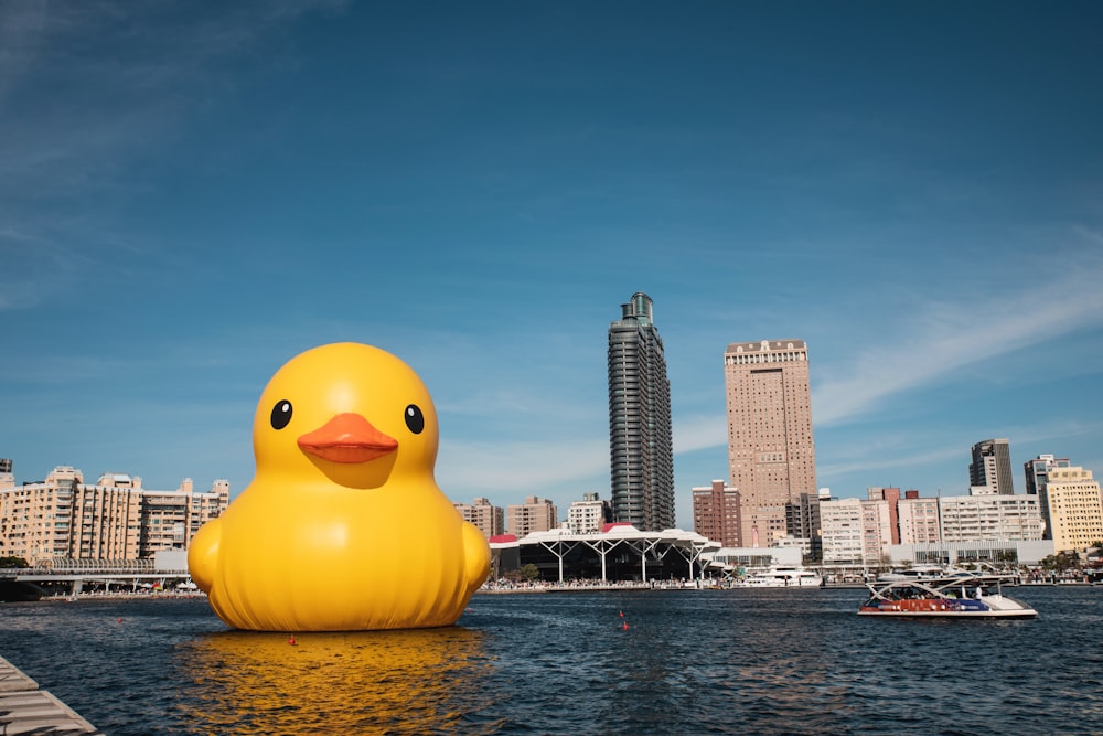 a large yellow rubber duck floating on top of a body of water