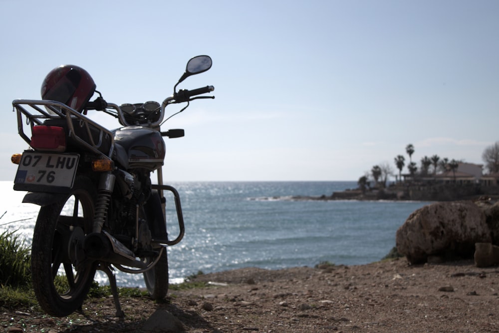 a motorcycle parked next to a body of water