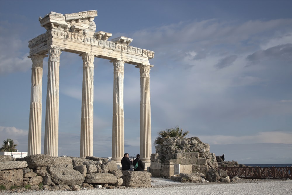 a group of people standing in front of a stone structure