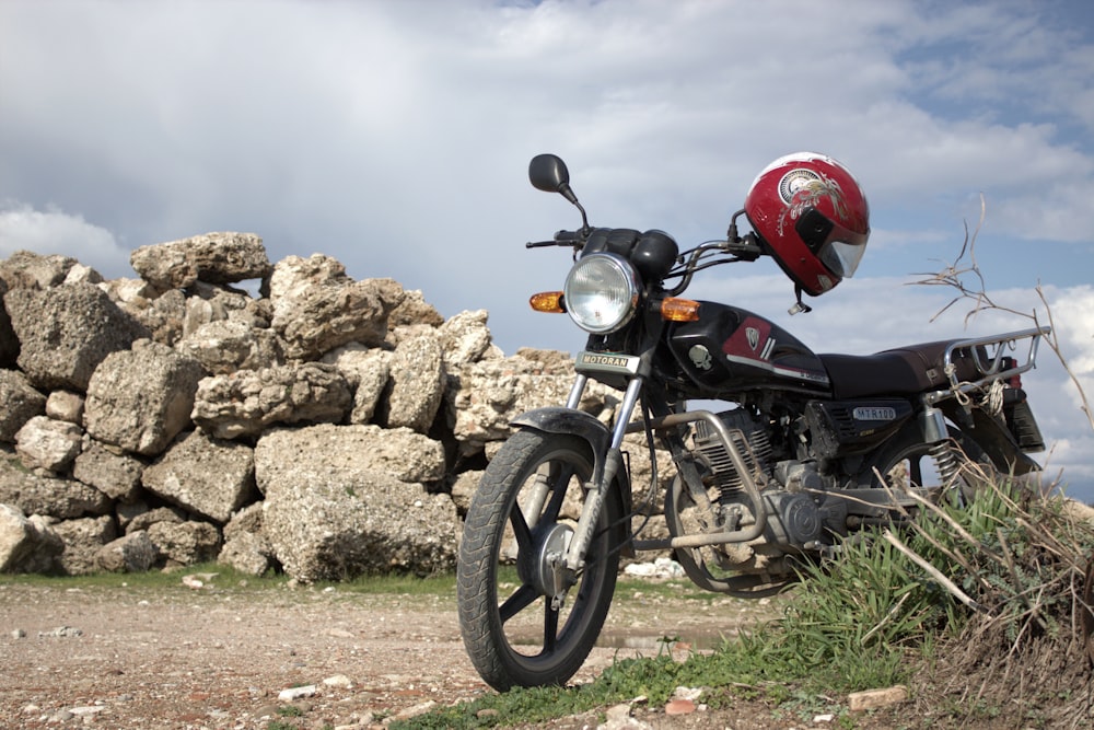 a motorcycle parked next to a pile of rocks