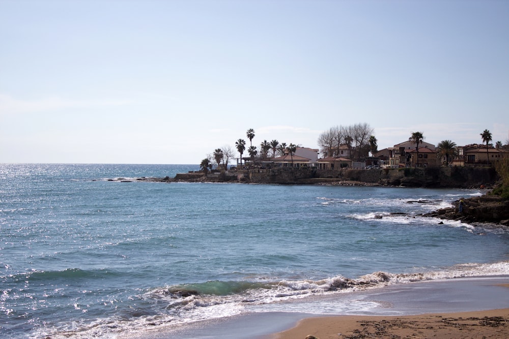 a body of water with houses in the background