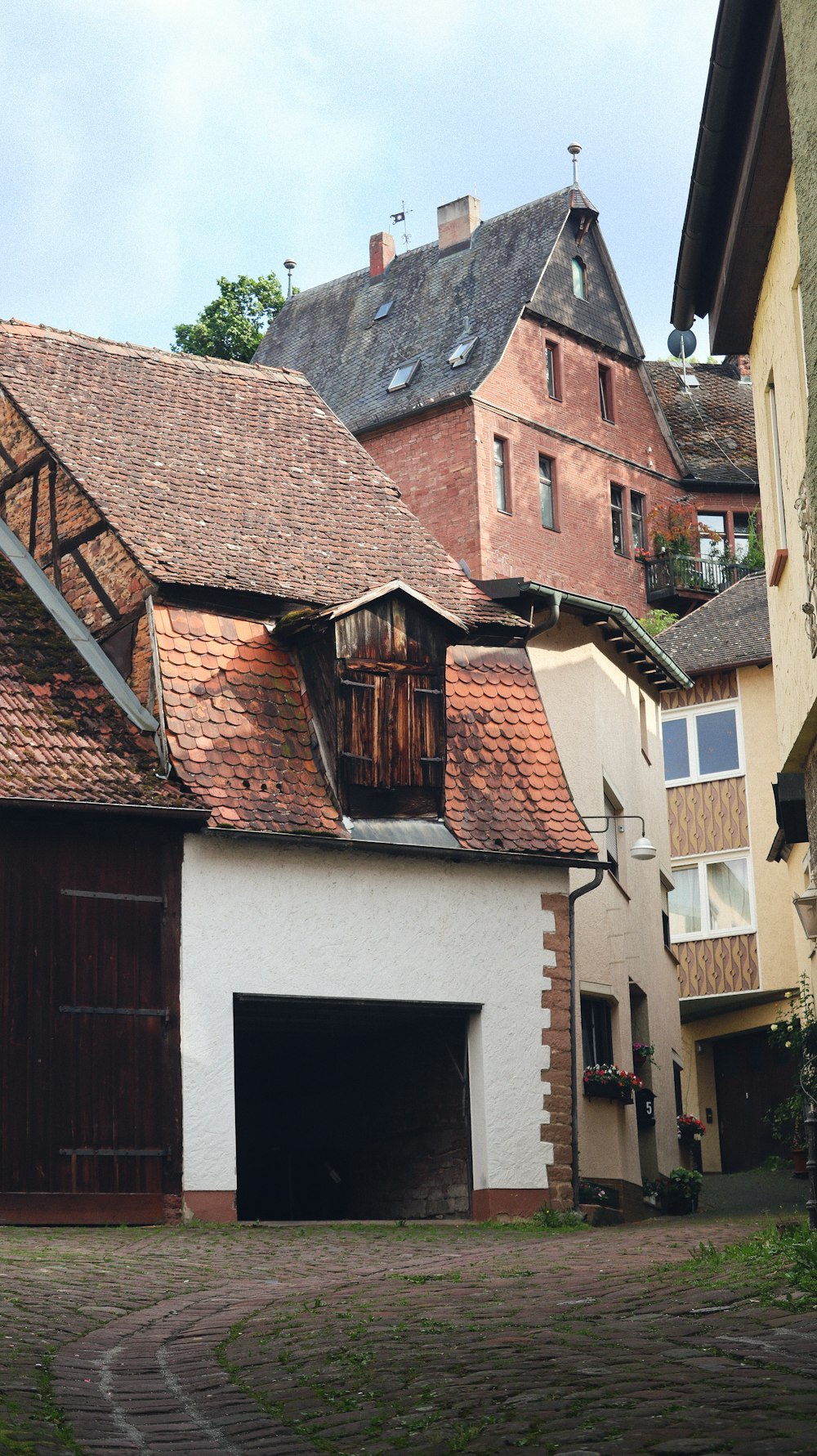 a brick building with a garage in front of it