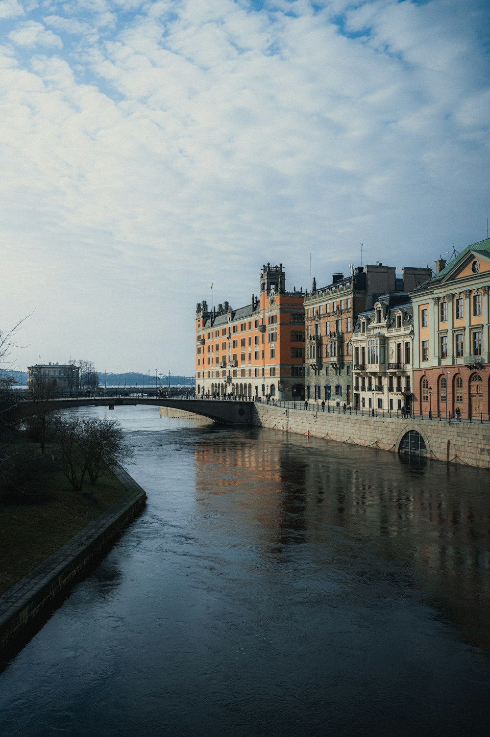 a river running through a city next to tall buildings