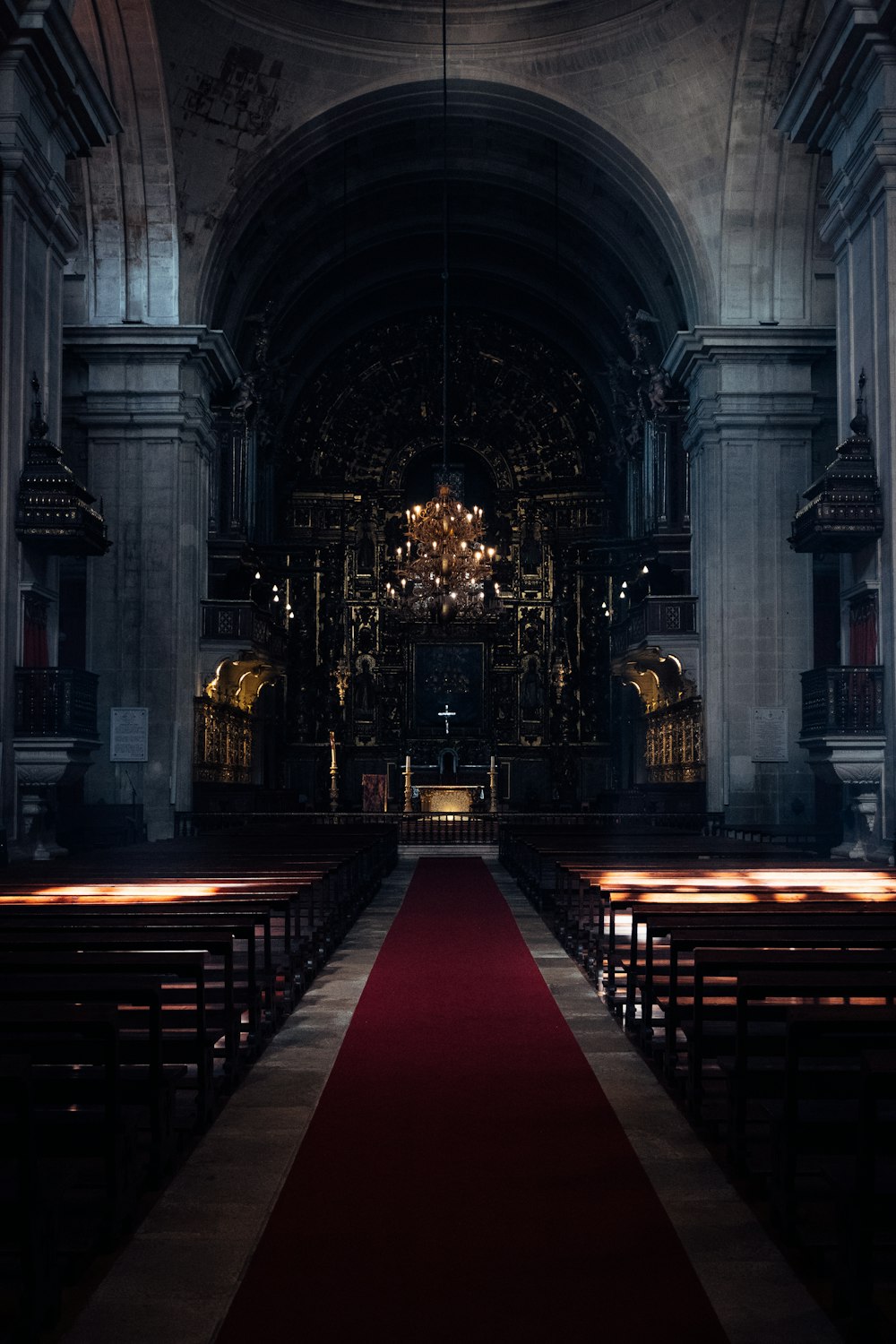 an empty church with pews and a red carpet