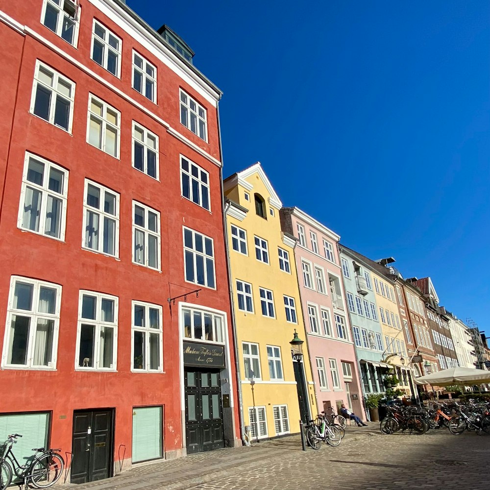 a row of buildings with bicycles parked in front of them