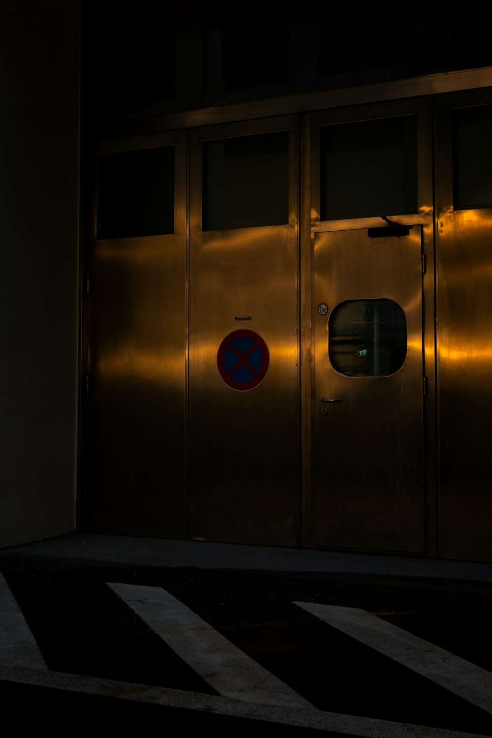 a metallic door with a blue and red sign on it