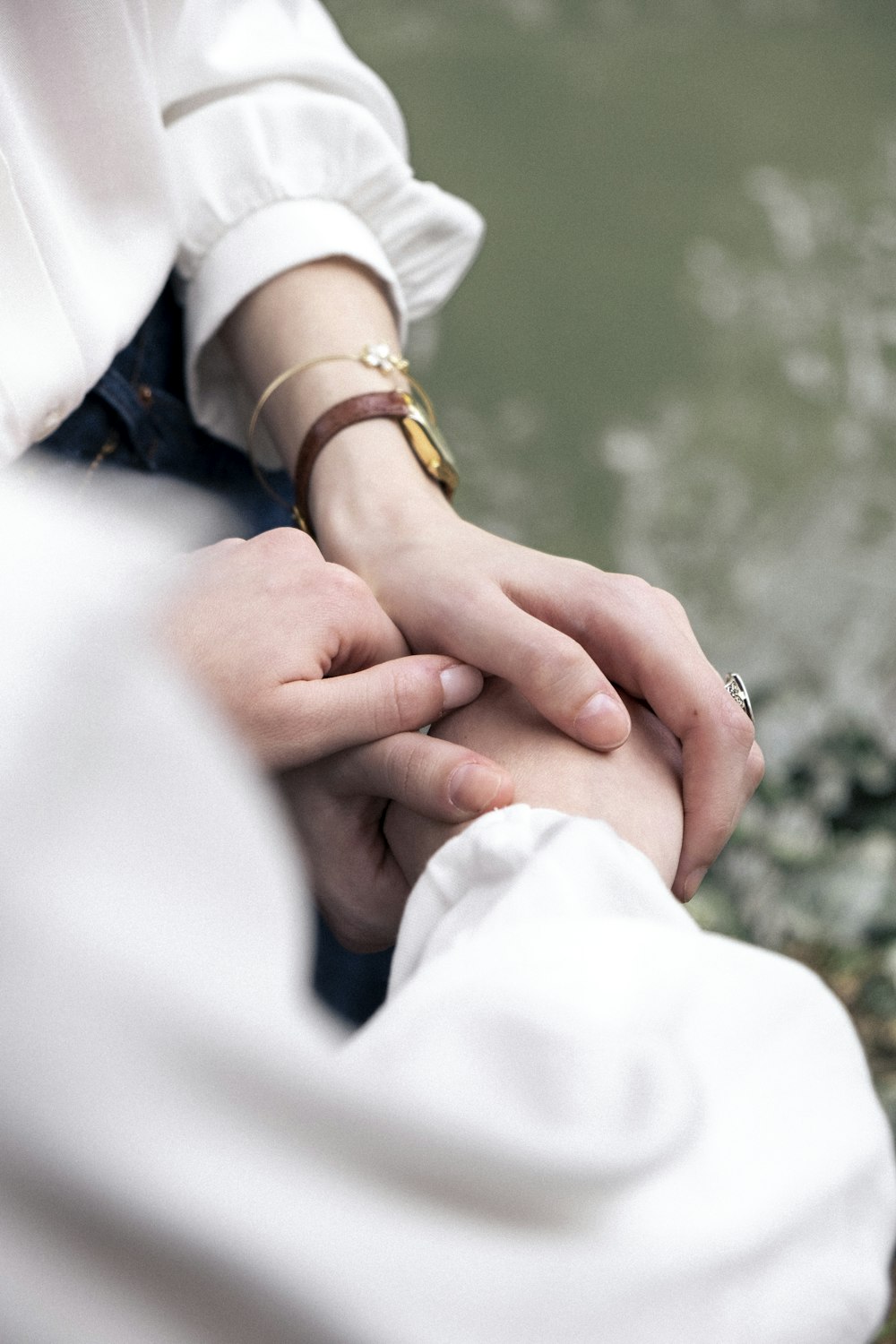 a close up of two people holding hands