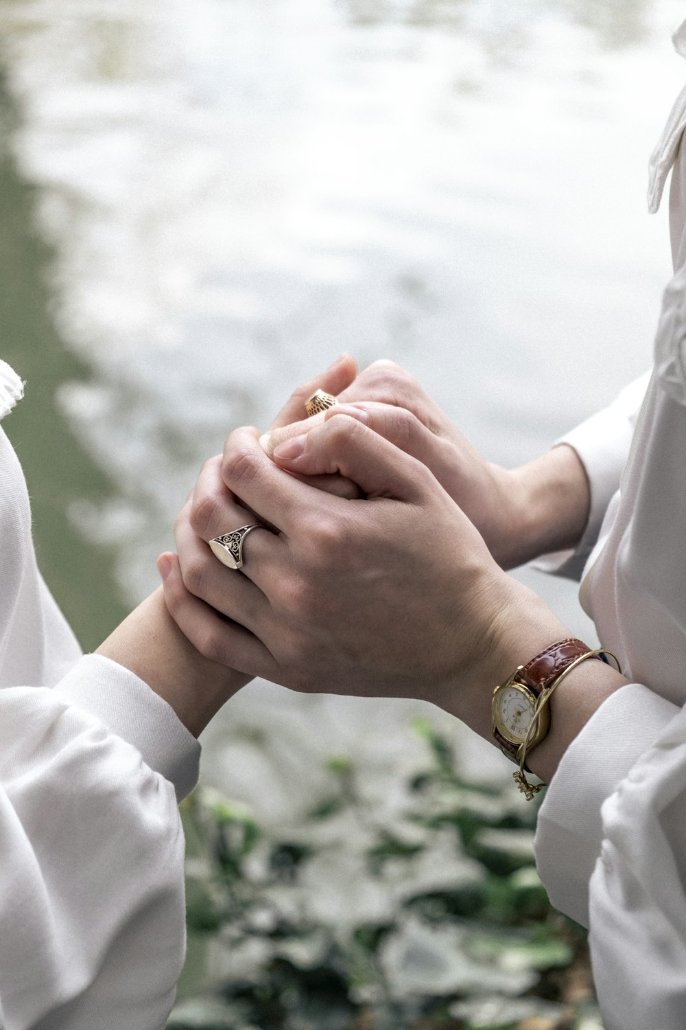 a close up of two people holding hands