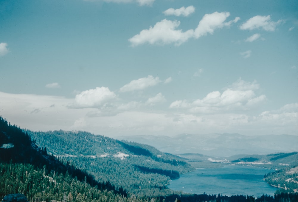 a scenic view of a lake surrounded by mountains