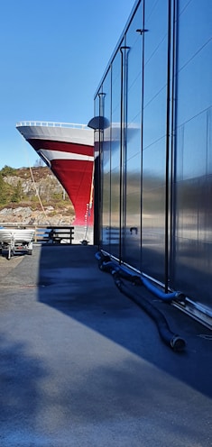 a large boat is parked next to a building
