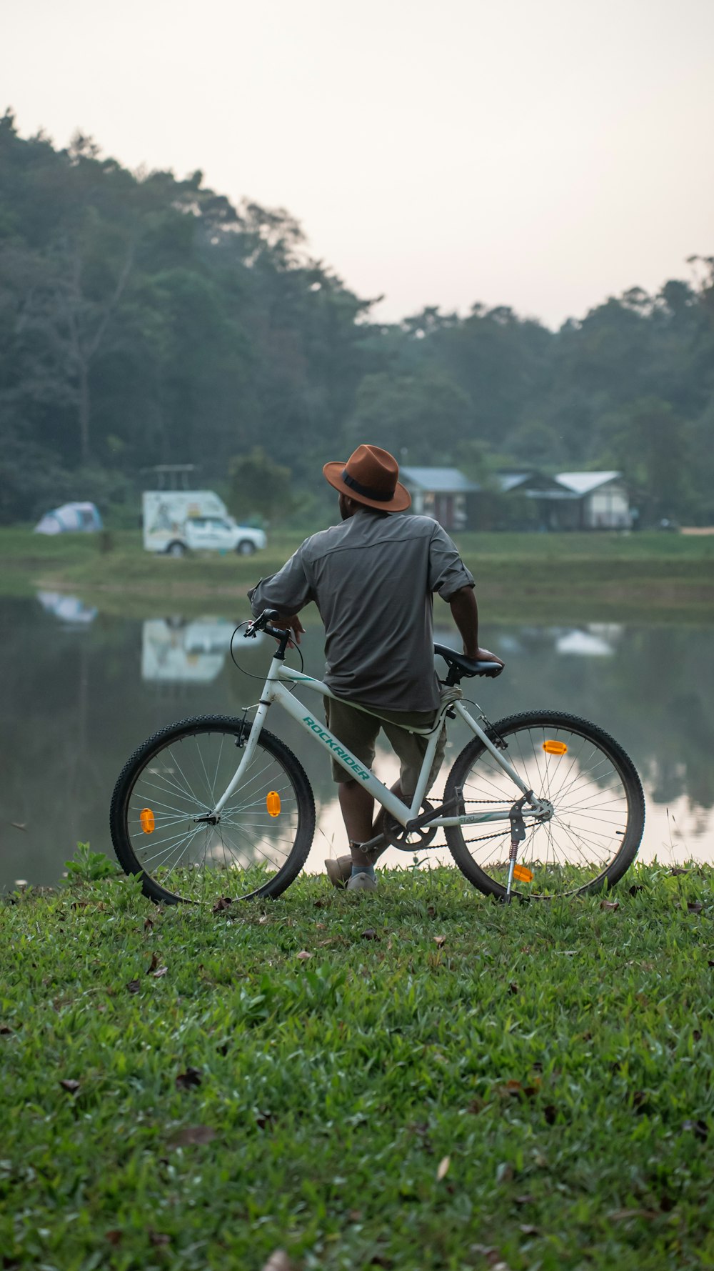 a man riding a bike next to a lake