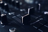 a close up of a sound board with knobs