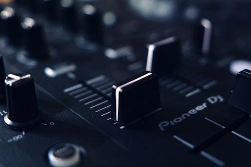 a close up of a sound board with knobs