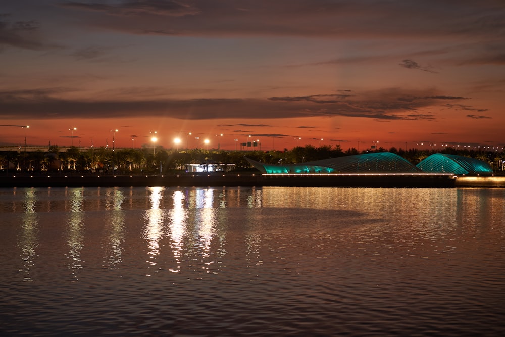 a large body of water with a building in the background