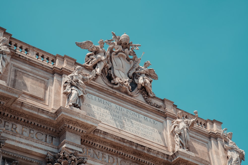 a statue on top of a building with a sky background