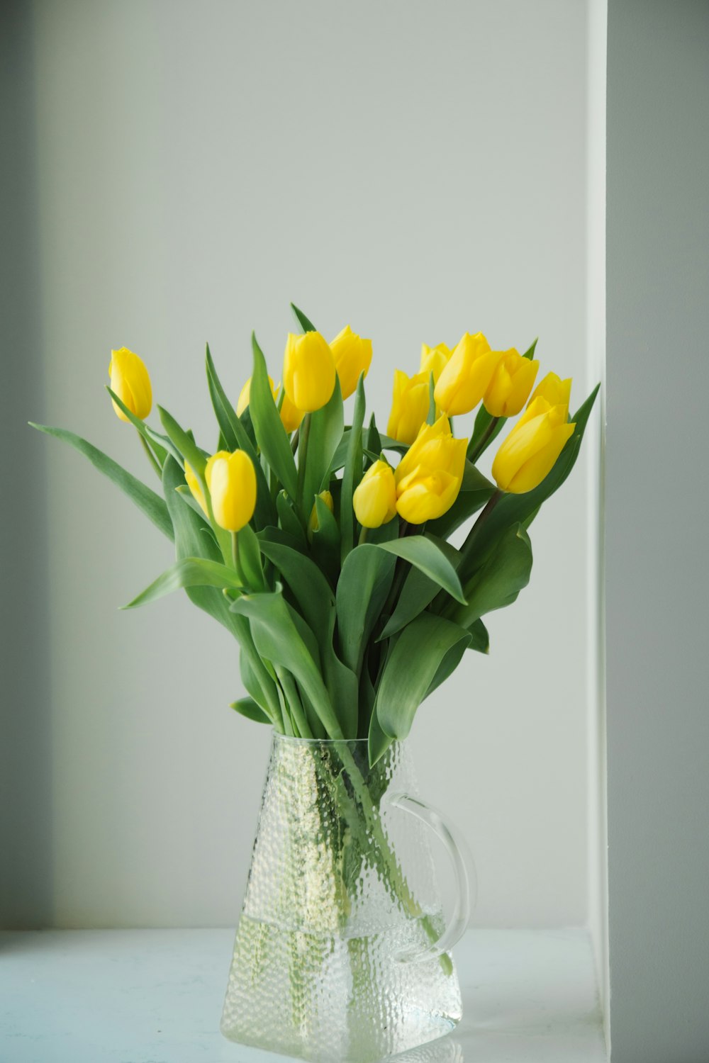 a vase filled with yellow flowers on top of a table