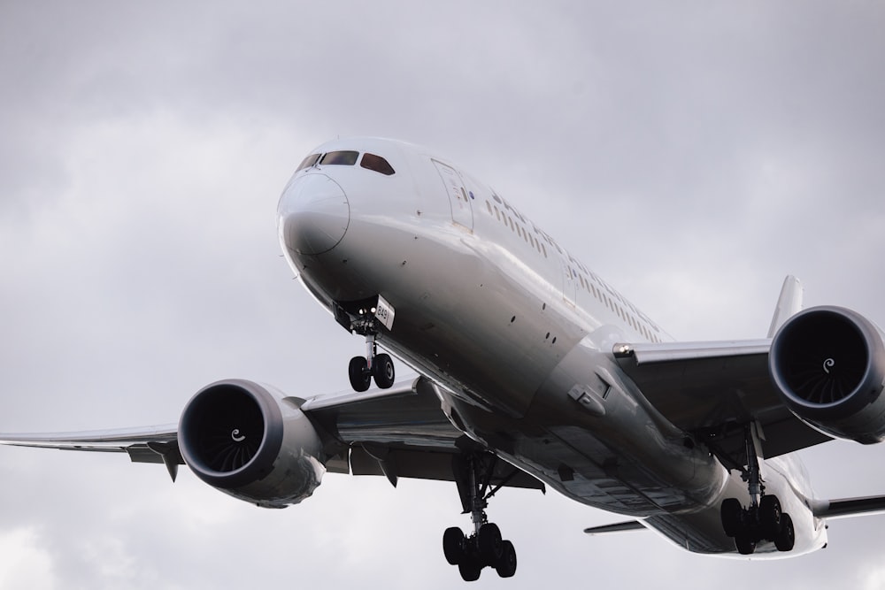 a large jetliner flying through a cloudy sky