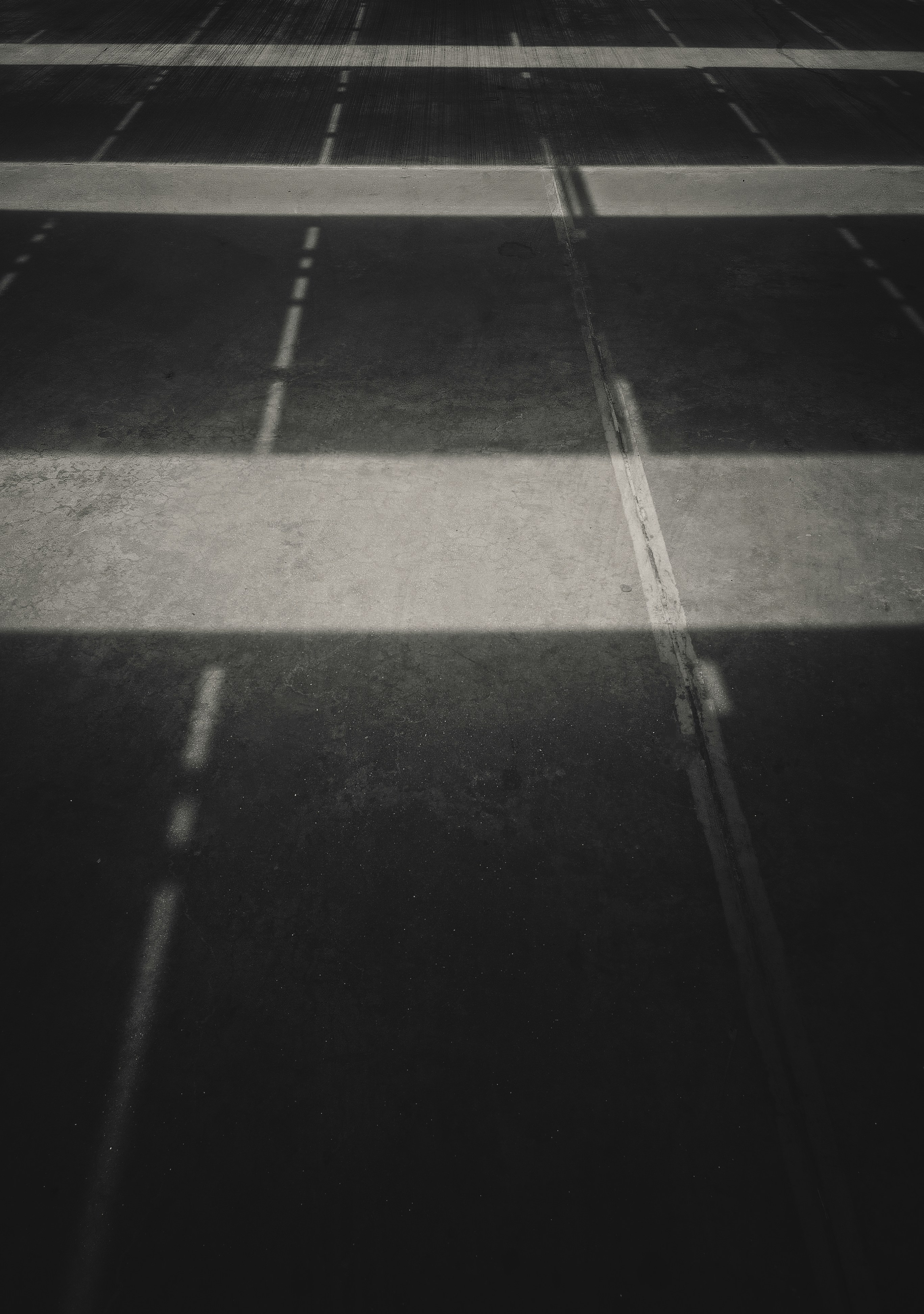 a black and white photo of an empty parking lot