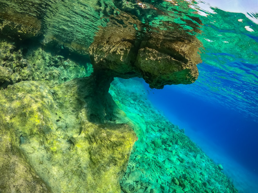 an underwater view of a rock formation in the ocean