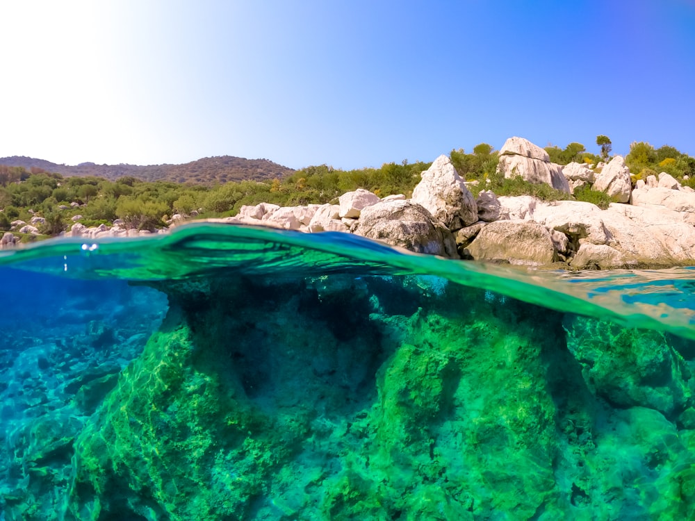 an underwater view of a rock formation in the ocean