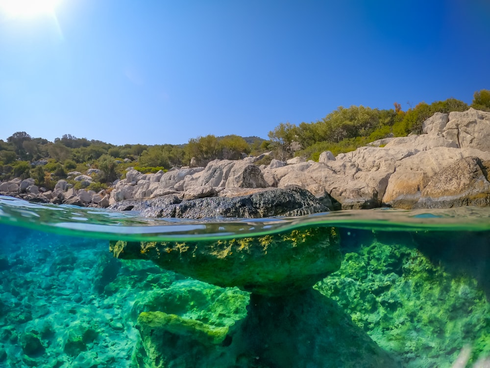 an underwater view of a rock formation in the ocean