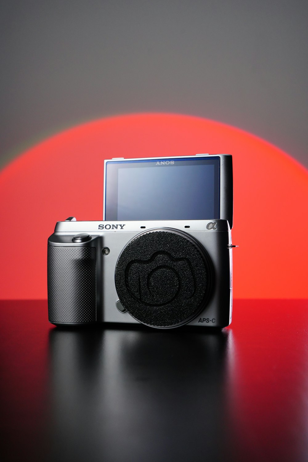 a sony camera with a red background behind it