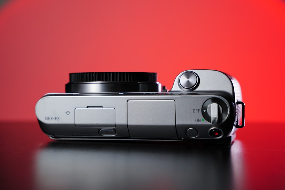 a silver camera sitting on top of a table