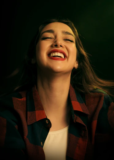 Woman laughing with eyes closed