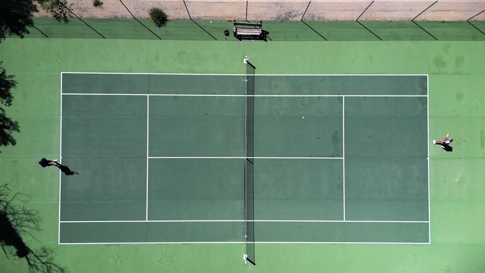 two people playing tennis on a tennis court