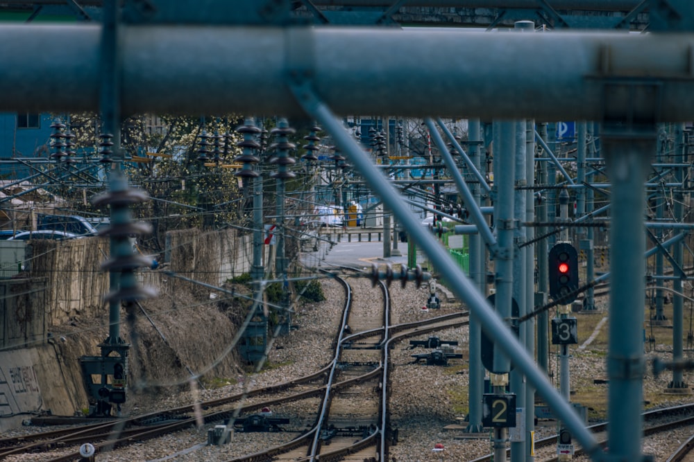 a train track with a red light in the middle of it