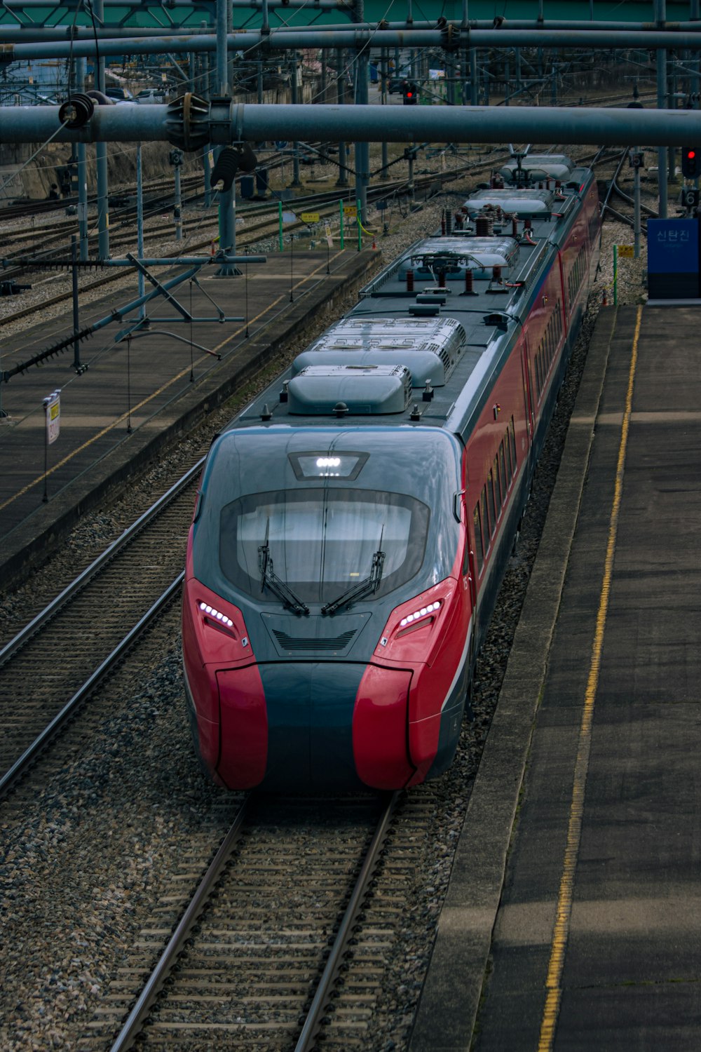 a red and blue train traveling down train tracks