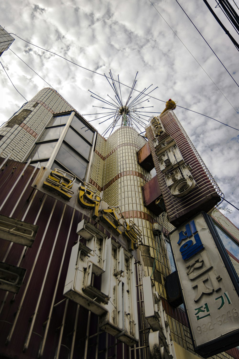 a very tall building with a ferris wheel in the background