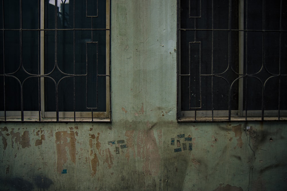 a man standing in a window of an old building