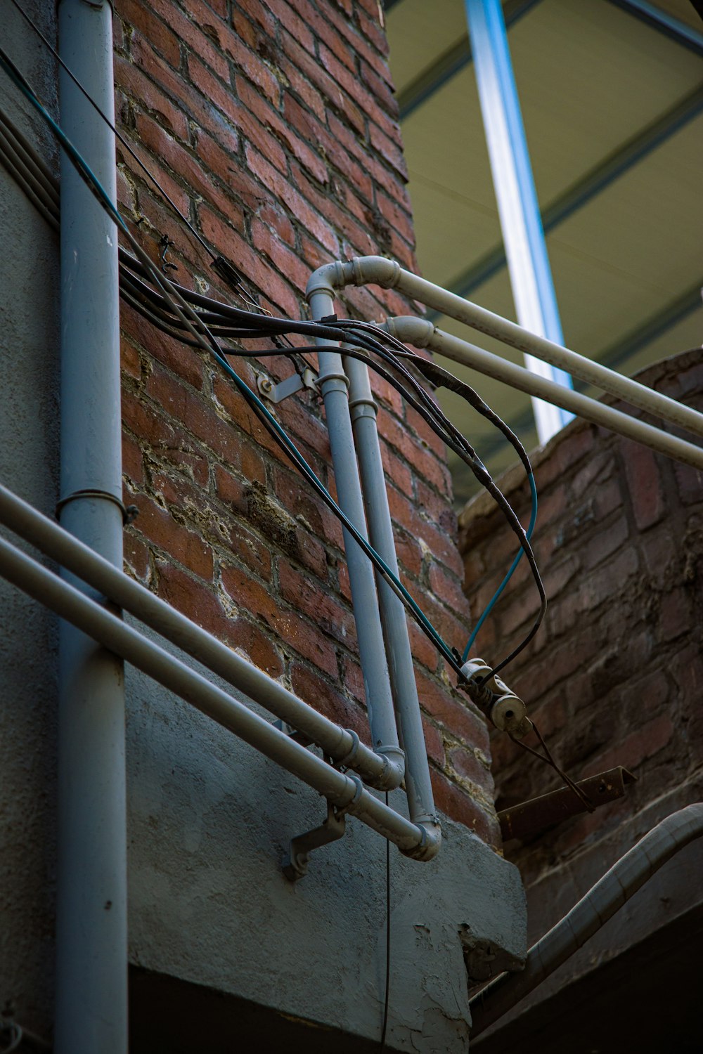 a close up of wires attached to a brick building