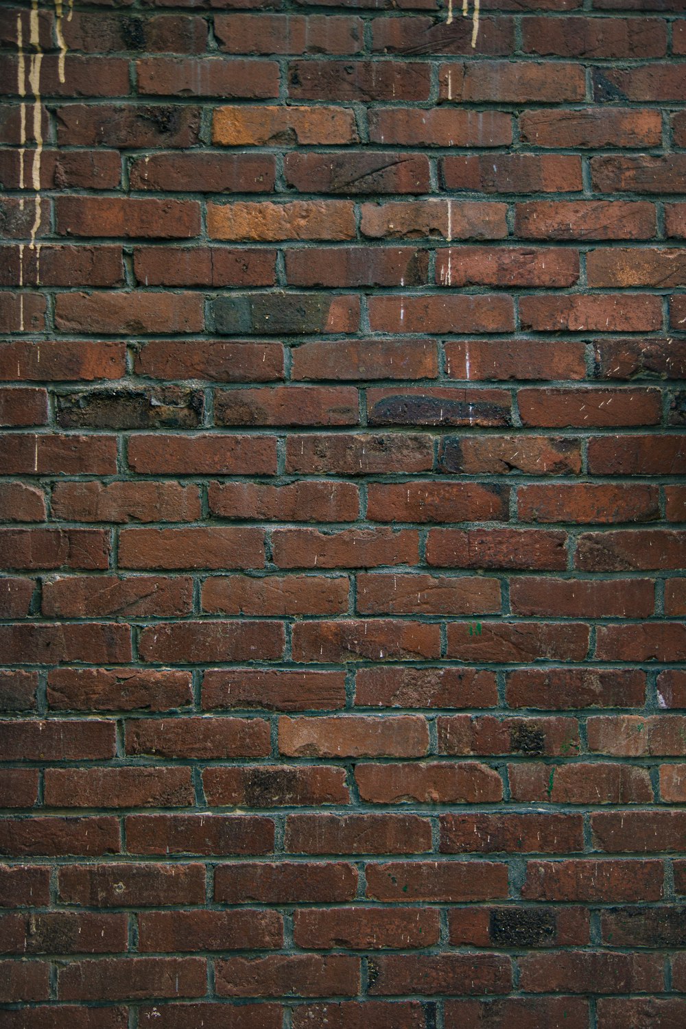 a brick wall with a stop sign on it