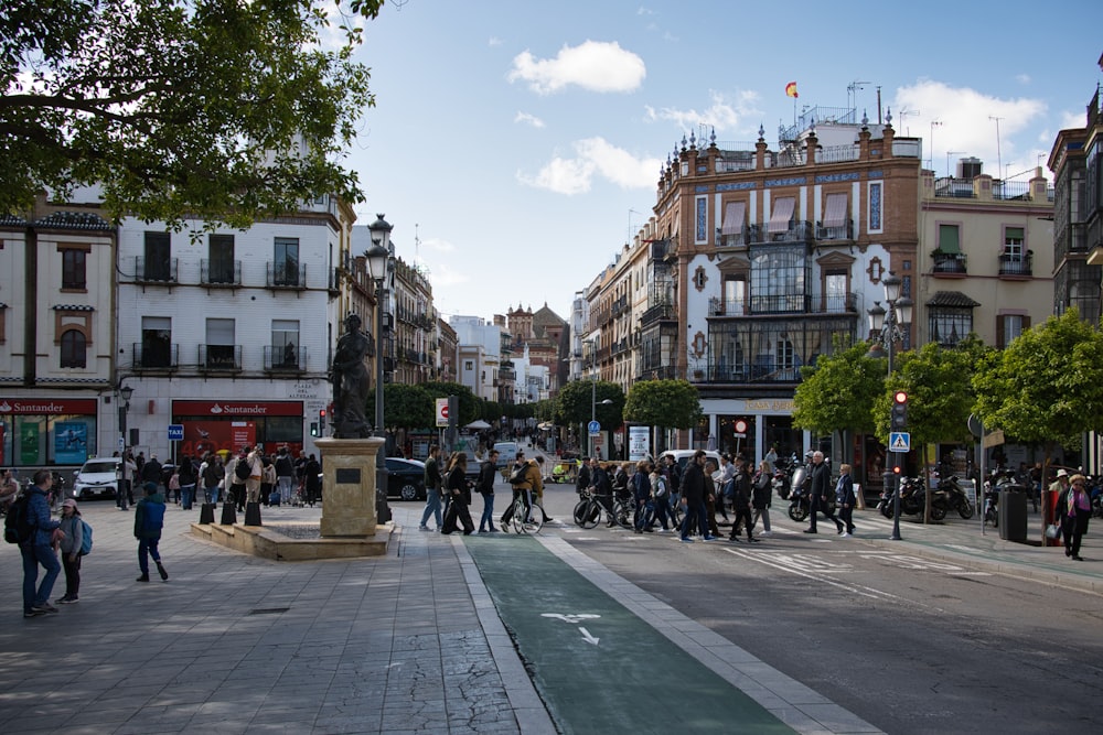 Un grupo de personas caminando por una calle junto a edificios altos