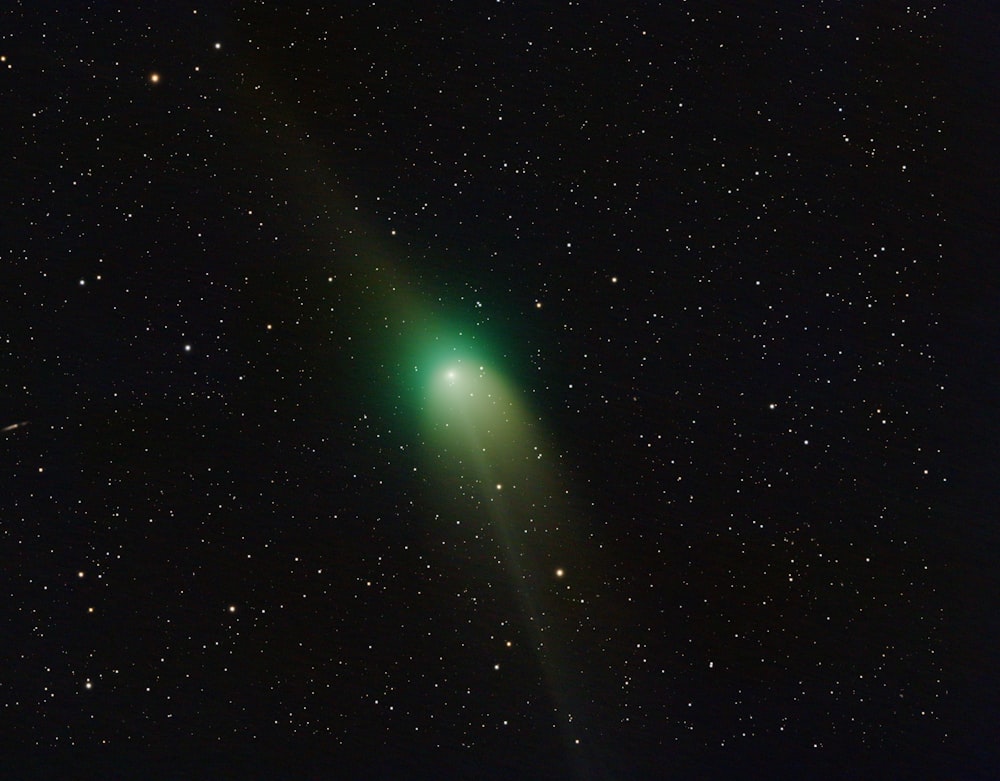 a bright green object in the middle of the night sky