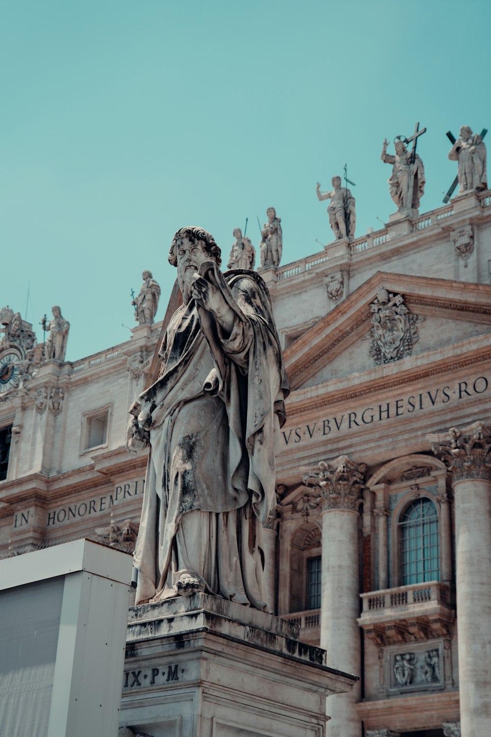 a statue of a man standing in front of a building