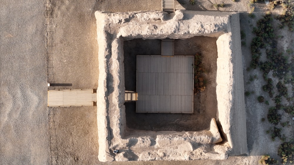 an aerial view of a cement structure with a fence