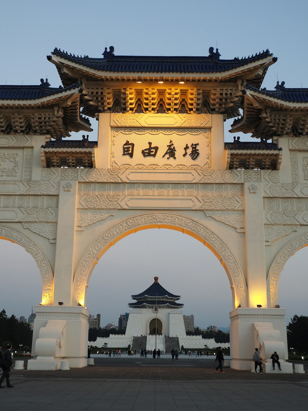 a large white arch with asian writing on it