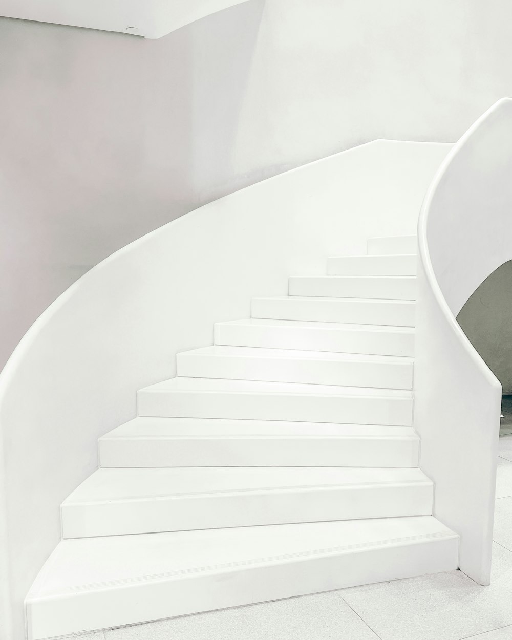 a white staircase with steps leading up to it