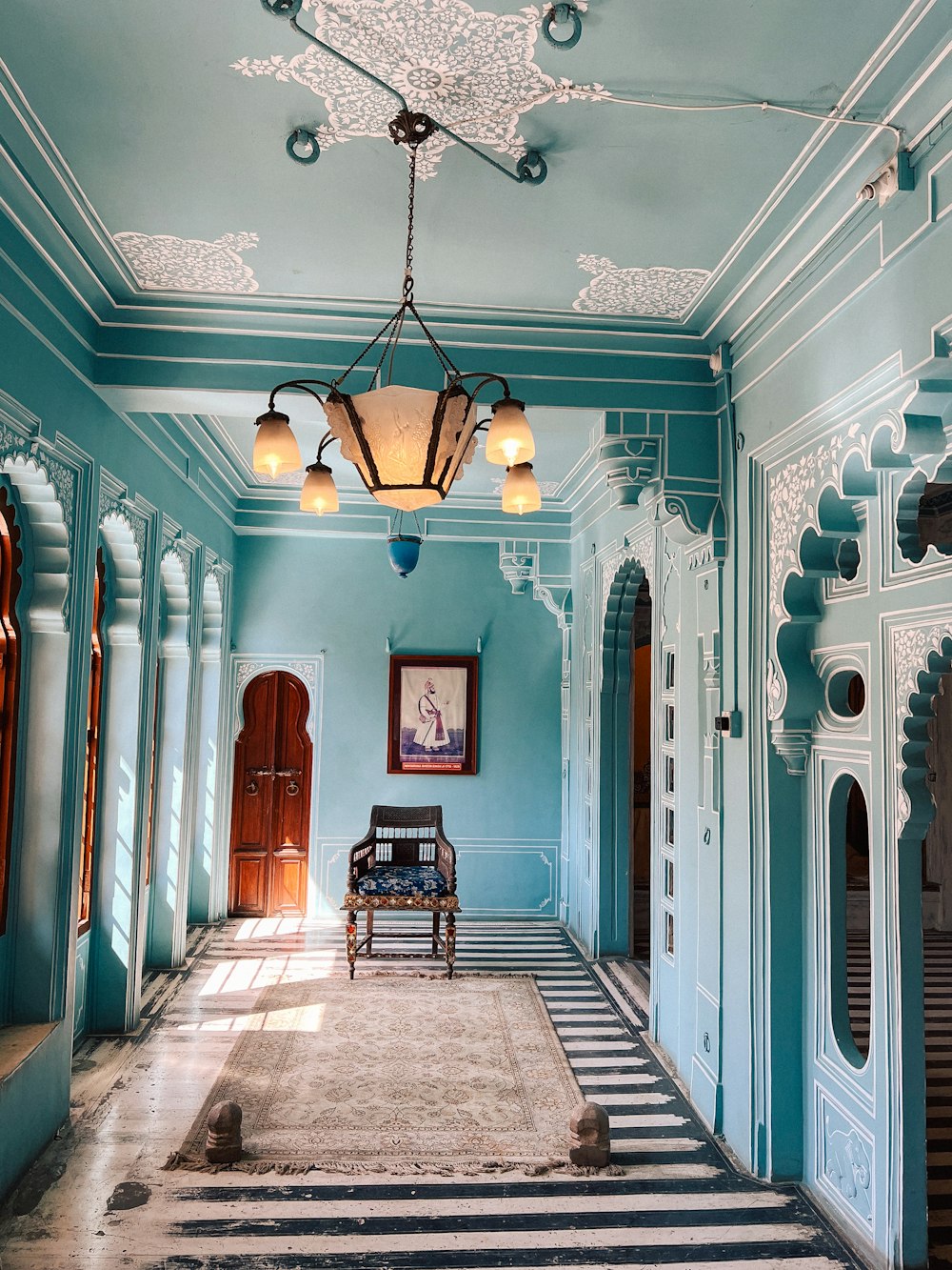 a blue room with a bench in the middle of it