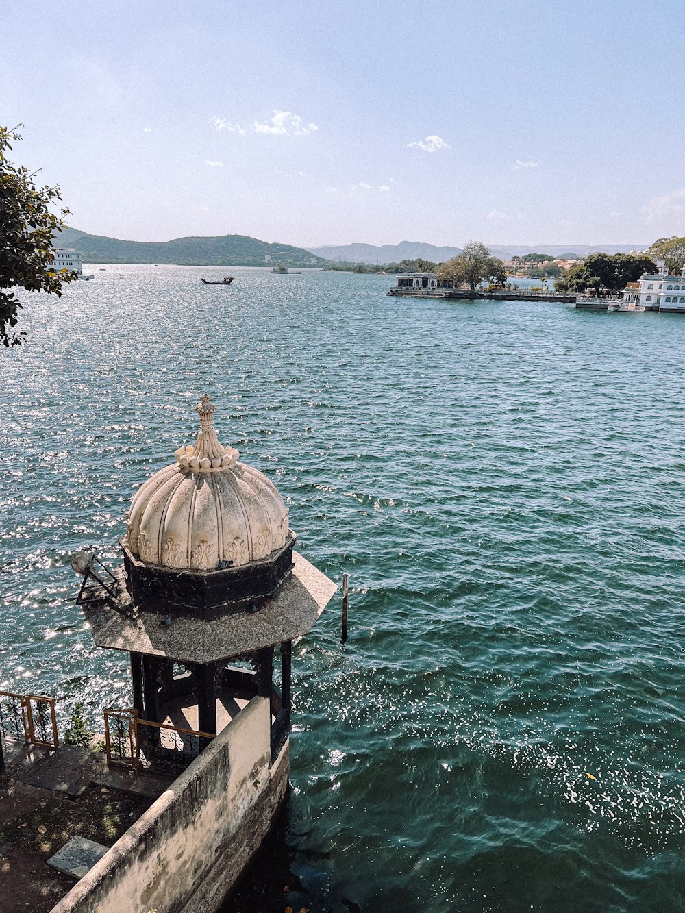 a gazebo sitting on the edge of a pier