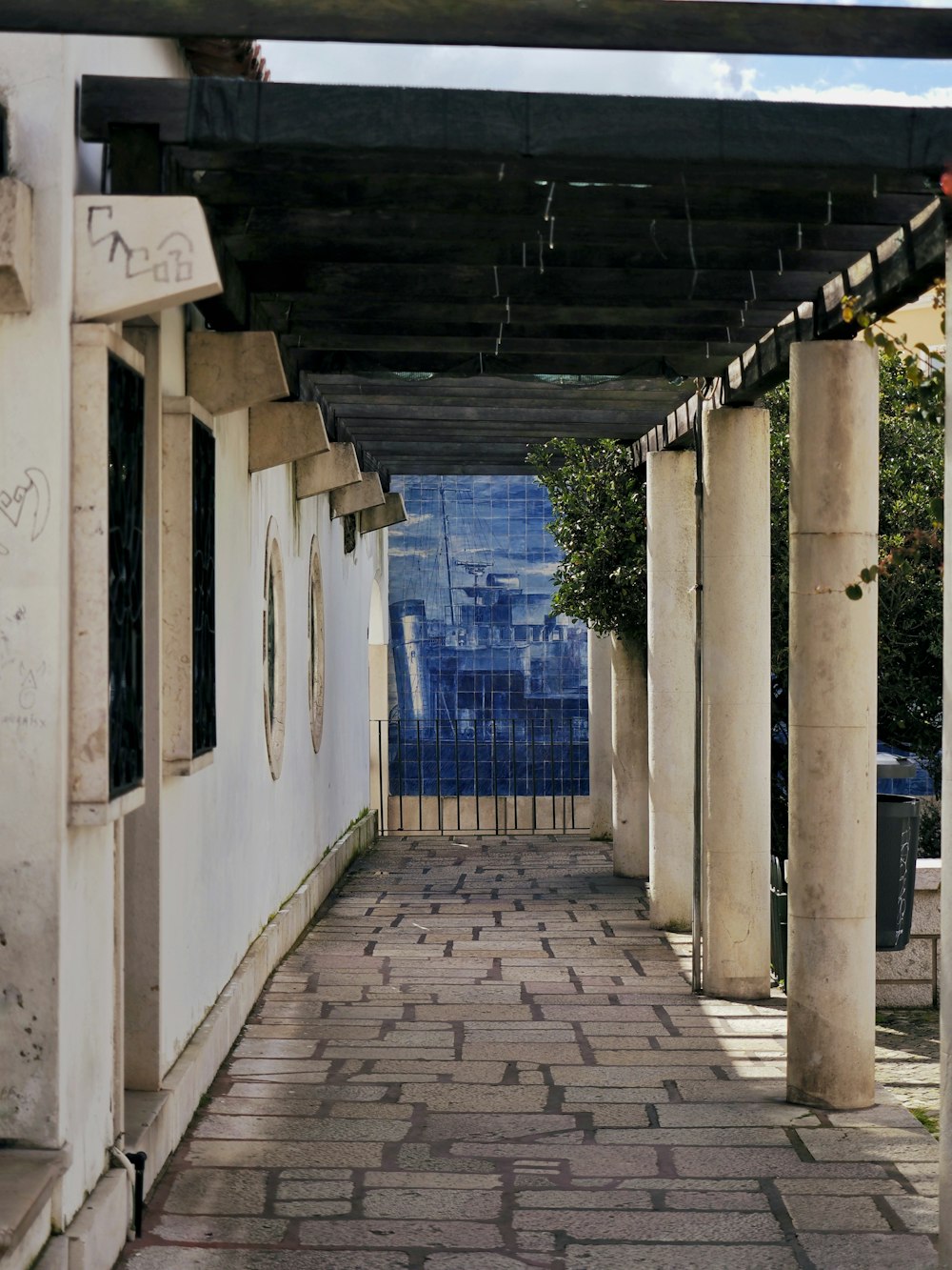 a walkway with a clock on the side of it