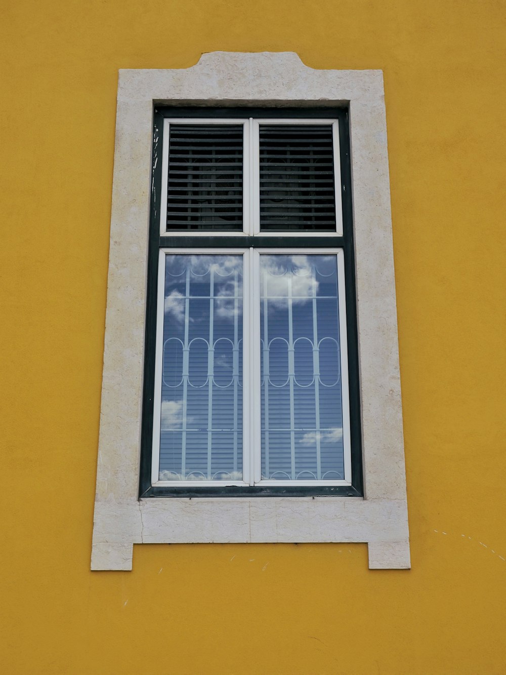 a window with a sky reflection in it