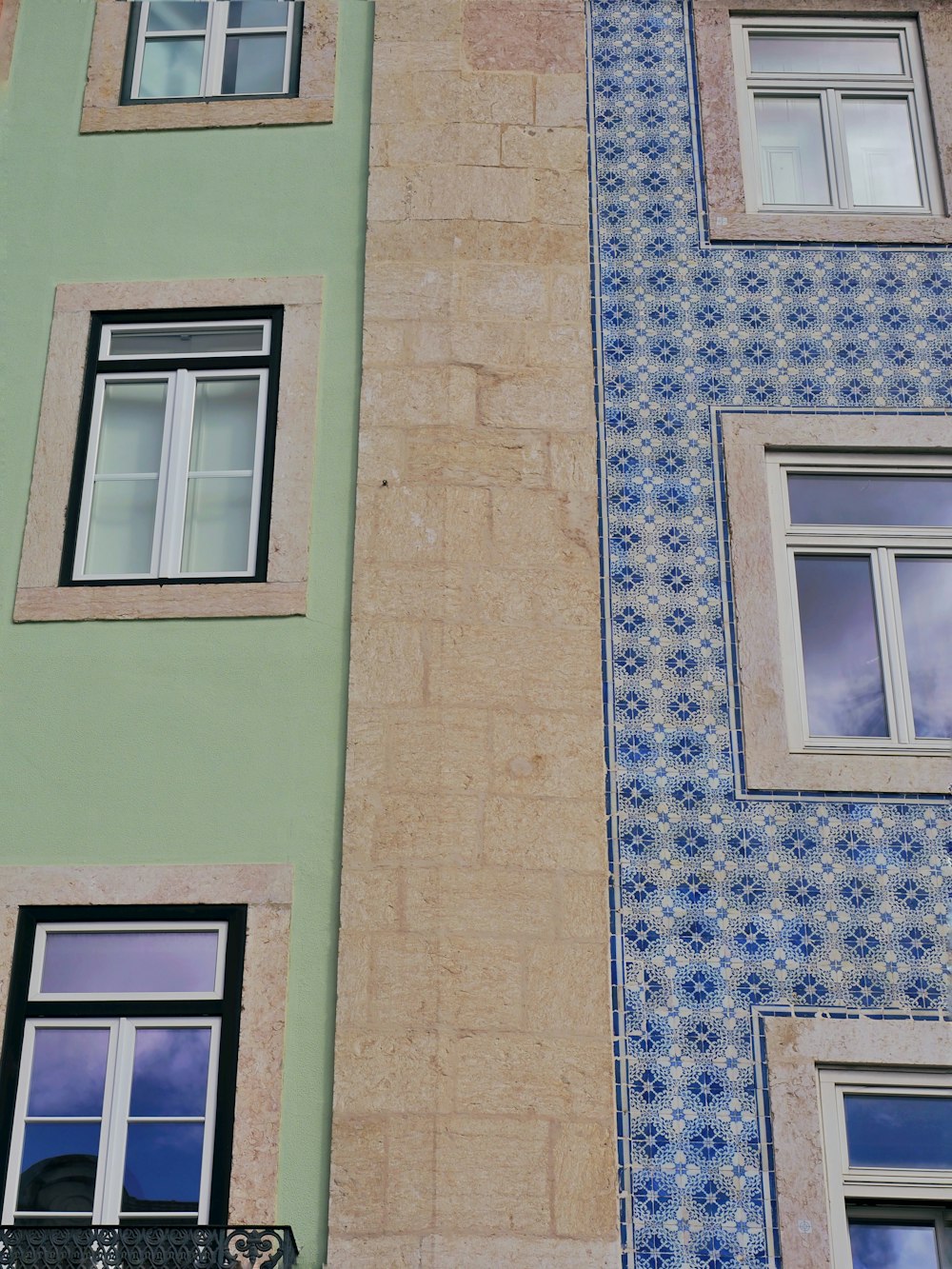 a building with two windows and a clock on the side of it