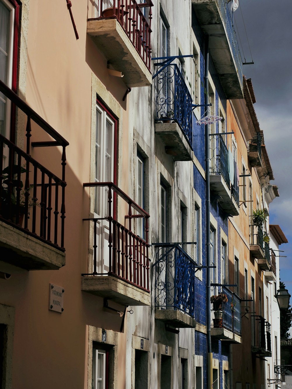 a row of multi - colored buildings with balconies and balconies on