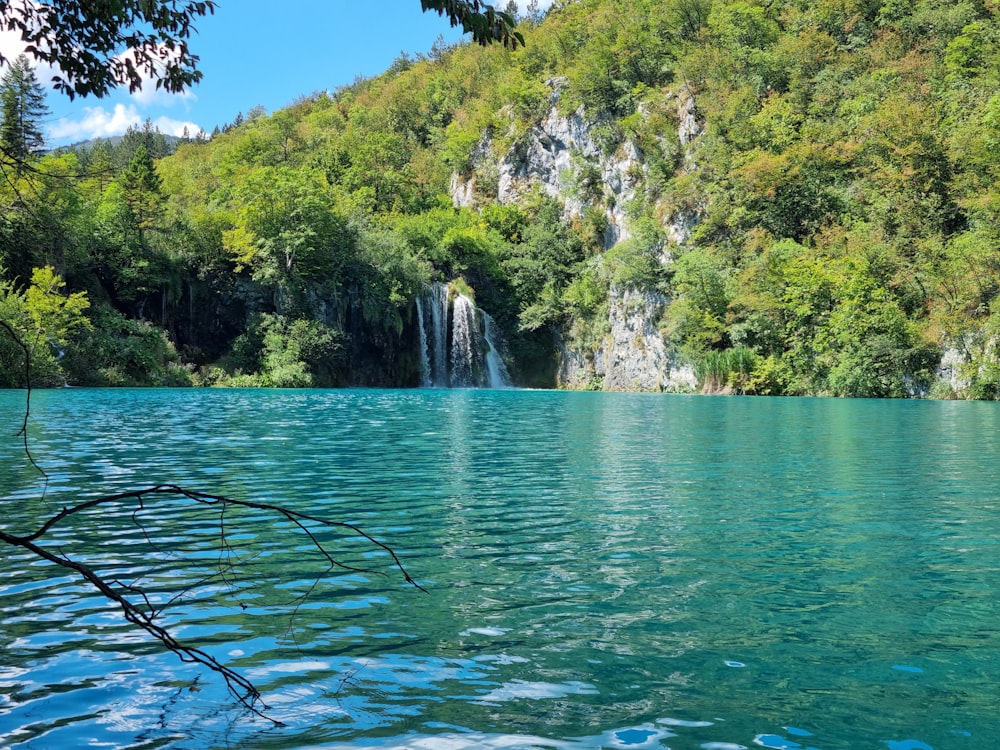 a body of water with a waterfall in the background